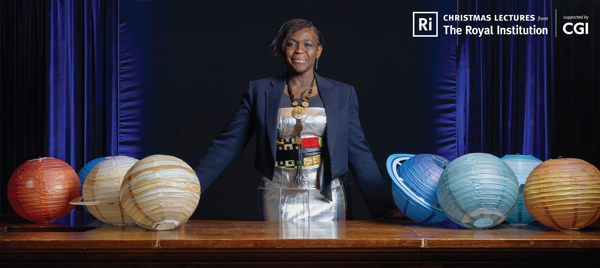 Maggie stands in the Theatre at the Faraday desk