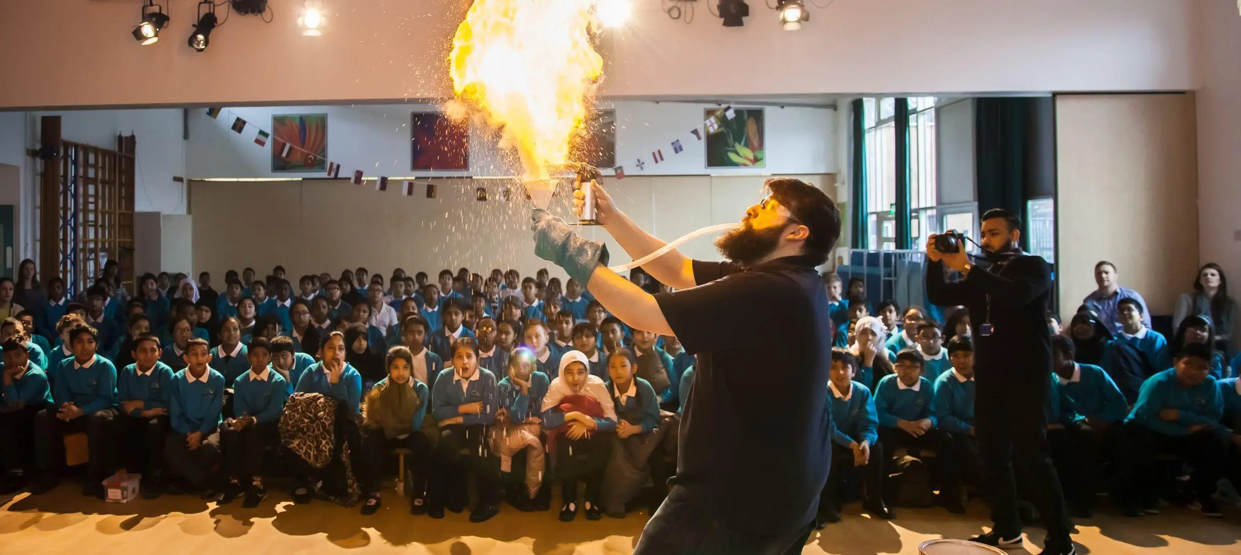 A fire demonstration in front of a group of schoolchildren watching