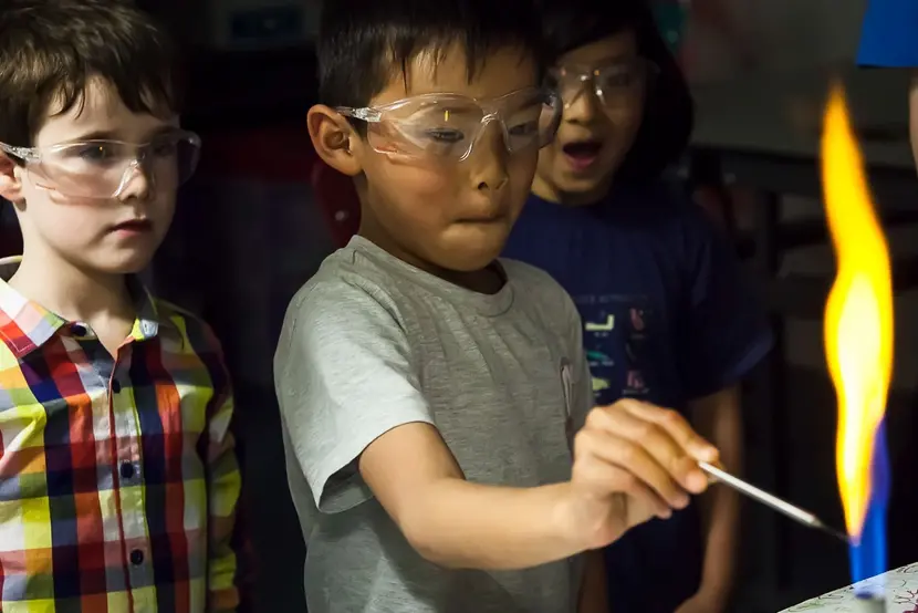Children look at a bunsen burner flame