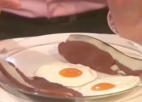 a plate of two fried eggs and two bacon rashers