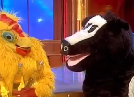 A person in a chicken costume and a person in a cow costume
