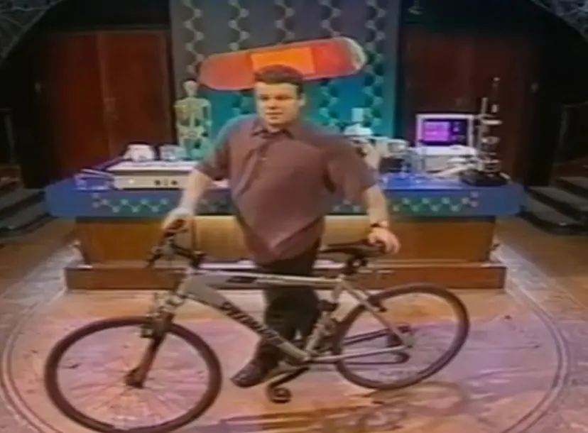 Tont Ryan standing behind a bicycle in the Ri theatre