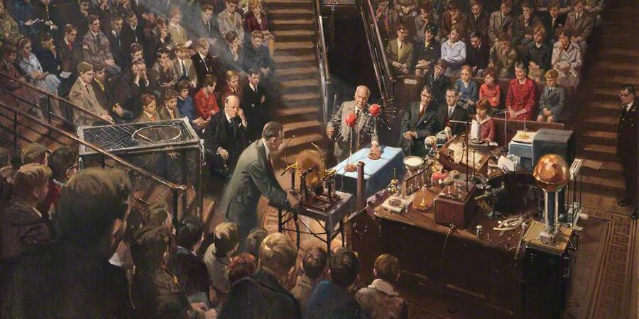 A painting of the 1961 Christmas Lectures taking place in a packed Ri theatre. Bill Coates has his back to the viewer, working on a demo with Laurence Bragg