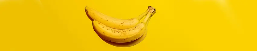 a bunch of ripe bananas on a yellow background
