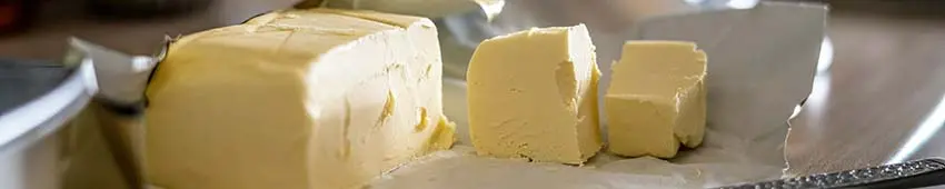 A soft block of butter on a cutting board