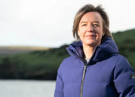 2020 Christmas Lecturer Tara Shine in a puffer jacket on a beach