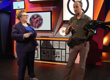 Sophie Scott standing next to a man who is holding a crow in the Ri theatre