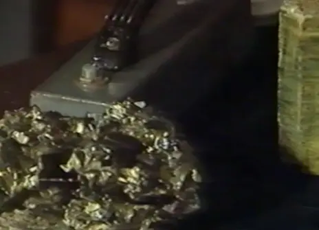 A jagged cystal, in front of a smooth crystal in the background