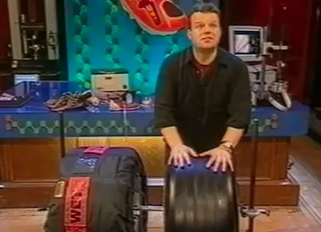 Tony Ryan standing behind two tyres in the Ri theatre
