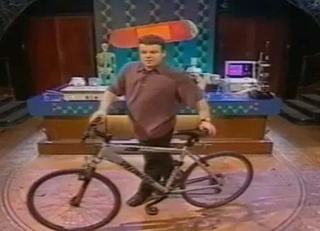 Tont Ryan standing behind a bicycle in the Ri theatre
