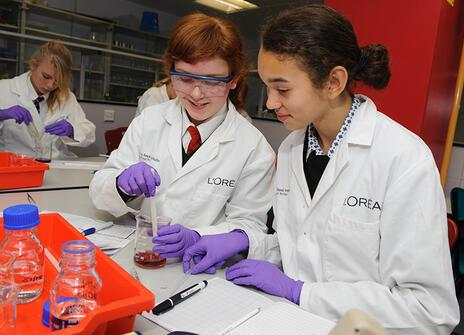 Two young ladies in the L'Oreal Young Scientist Centre at the Ri, conducting an experiment with pipettes