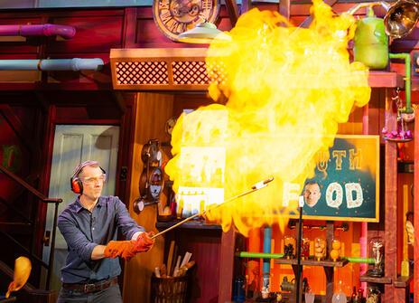 Chris van Tulleken igniting a balloon full of flammable gas