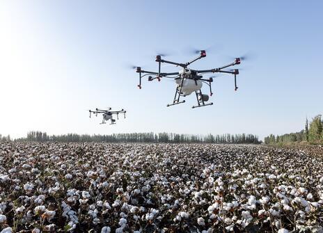 Image of drones hovering over a field