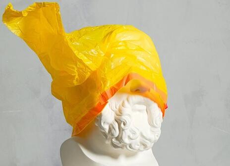 Statue with a yellow plastic bag covering the head