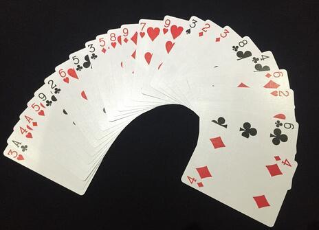 cards are spread out over a black background