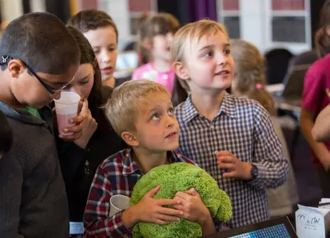 children are standing and looking up.