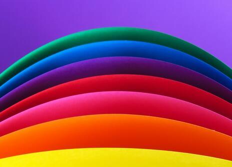 layers of colour - yellow, orange, pink, red, purple, blue, dark green, all on a light purple background