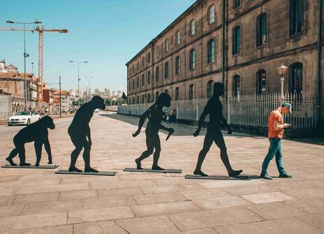 The evolution man, finishing with a man looking at his phone