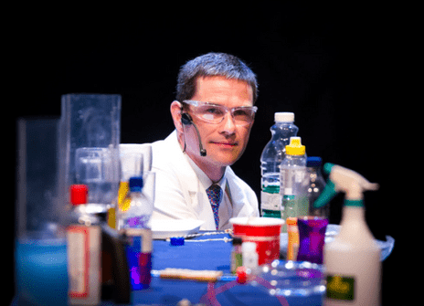 a man is sitting behind a table of items found in a kitchen