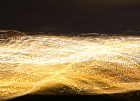 streams of yellow light lines run horizontally across a black background. 