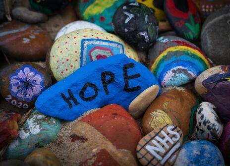 Painted pebbles with the words NHS, hope and 2020